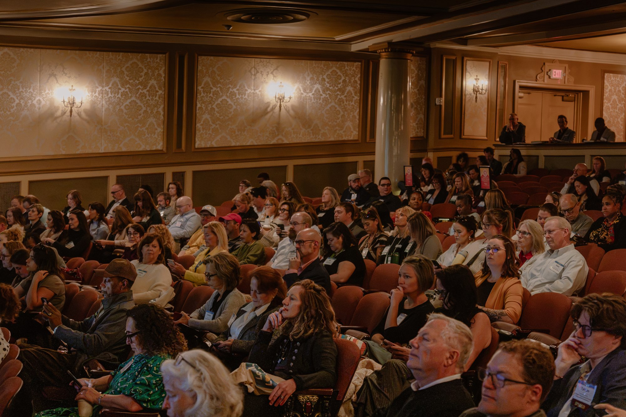 Conference attendees filling the auditorium at the Maryland Theatre